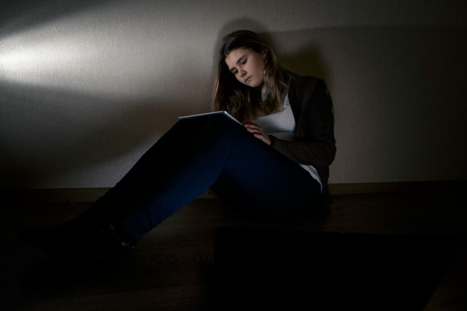 girl sitting in the dark