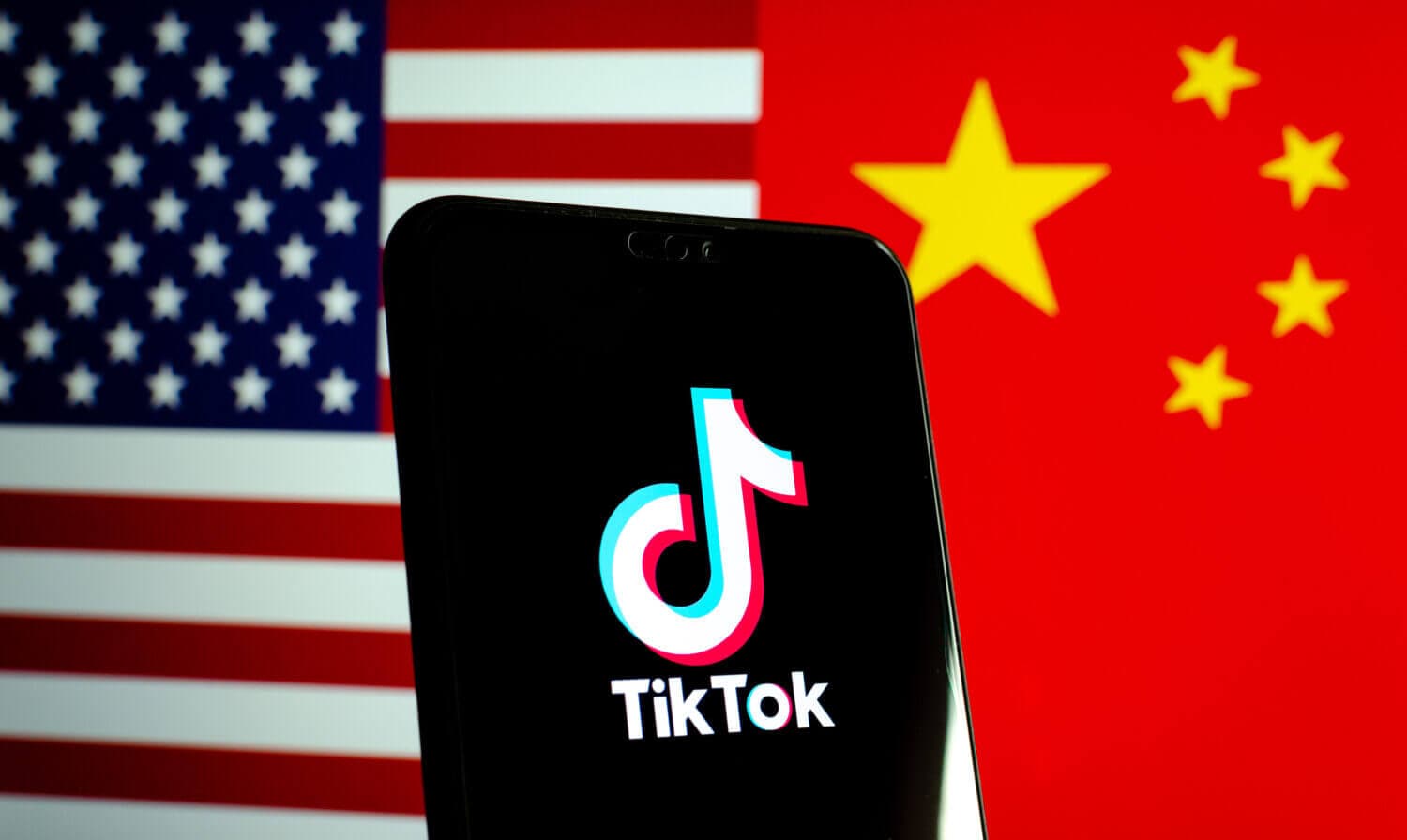 tiktok app on a phone with USA and China flag